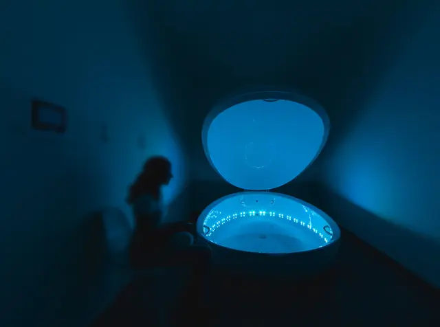 Float pod glowing blue in a dark room