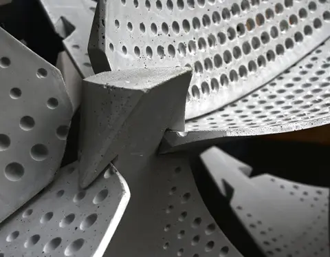 Close view of the perforated, ribbed concrete shells