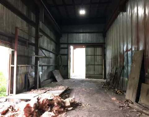 The same bay before renovation, with worn cladding and debris