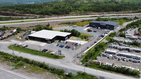 Aerial photo of the completed site with both buildings, parking and the highway