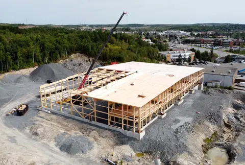Aerial photo of the timber frame being erected with a crane
